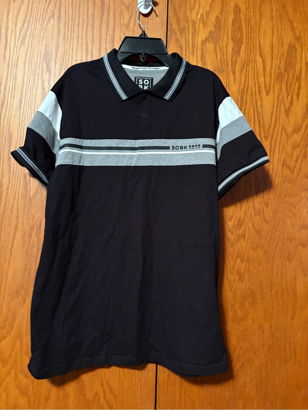 Black Polo with Gray and White Stripe Detail